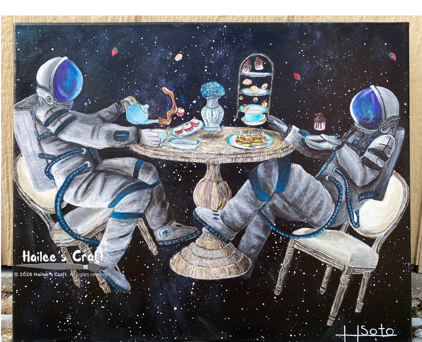 Artwork titled A Great Space For Tea. This painting depicts two astronauts sitting at a round wooden table. They are floating in space surrounded by stars. The table is decorated for a tea party. Cakes, pastries and flowers are all hovering above the table. The astronaut on the left is trying to pour a cup of tea, but the liquid is floating away. The astronaut on the right is reaching for his tea cup waiting for his turn to pour tea. He is also holding a plate with a small strawberry cake on it.